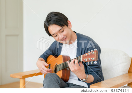 Man playing the guitar Living room 98874124