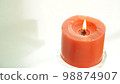 red candle on a white background 98874907