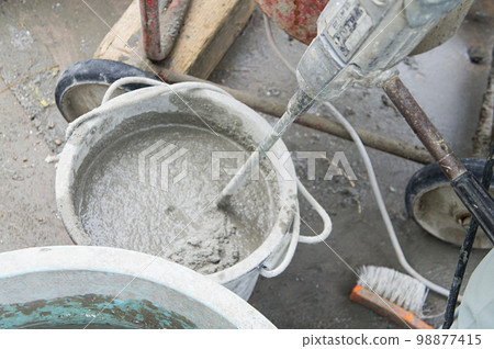 Plastering work at a construction site Mortar making 98877415