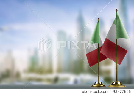 Small flags of the Italy on an abstract blurry background Small flags of the Italy on an abstract blurry background 98877606