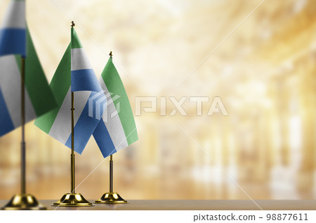 Small flags of the Sierra Leone on an abstract blurry background 98877611