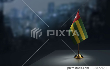 Small flags of the Togo on an abstract blurry background 98877632