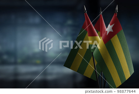 Small flags of the Togo on an abstract blurry background 98877644