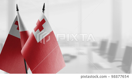 Small flags of the Tonga on an abstract blurry background 98877654