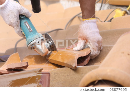 Roof tile repair work by a tile craftsman 98877695