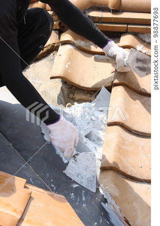 Roof tile repair work by a tile craftsman 98877698