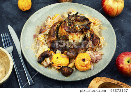 Pork knuckle prepared in sauerkraut. 98878167