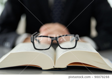 Image of intellectual labor with glasses and dictionaries Image of intellectual labor with glasses and dictionaries 98878288