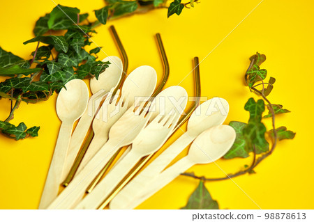 Flat lay reusable stainless steel straws and eco wooden spoons Flat lay reusable stainless steel straws and eco wooden spoons 98878613
