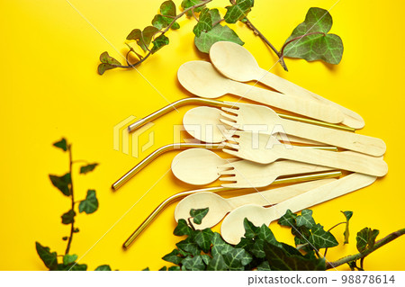 Flat lay reusable stainless steel straws and eco wooden spoons Flat lay reusable stainless steel straws and eco wooden spoons 98878614