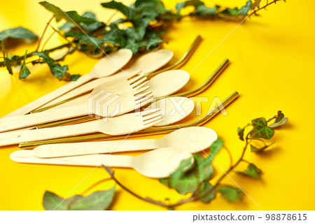 Flat lay reusable stainless steel straws and eco wooden spoons Flat lay reusable stainless steel straws and eco wooden spoons 98878615