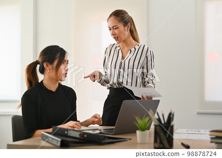 Dissatisfied team leader scolding frustrated young employee. Emotional pressure, stress at work 98878724