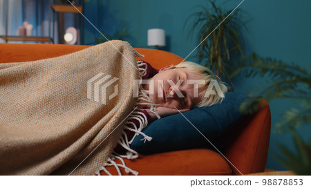 Tired blonde young woman lying down in bed taking a rest at home, napping falling asleep on sofa Tired blonde young woman lying down in bed taking a rest at home, napping falling asleep on sofa 98878853