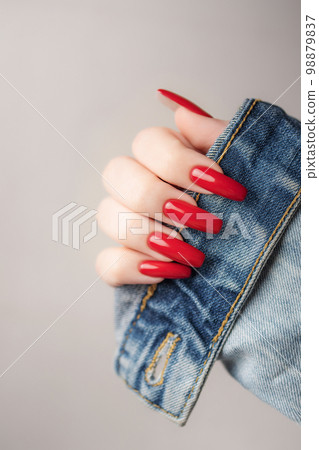 Hand of a young girl with red  manicure on nails 98879837