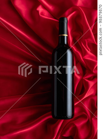 Bottle of red wine on a satin background. Bottle of red wine on a satin background. 98879870