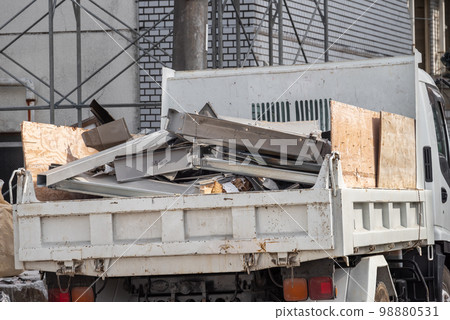 Truck collecting scrap metal at a demolition site Truck collecting scrap metal at a demolition site 98880531