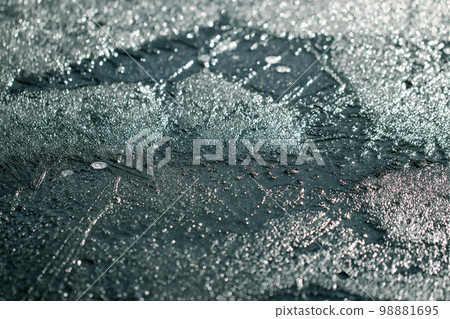 A frozen pond water surface texture that sparkles in a mysterious glacier color from blue to red. A frozen pond water surface texture that sparkles in a mysterious glacier color from blue to red. 98881695