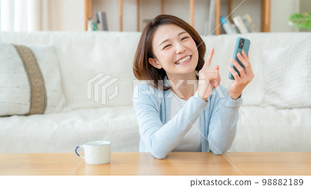 Middle woman with smartphone 98882189