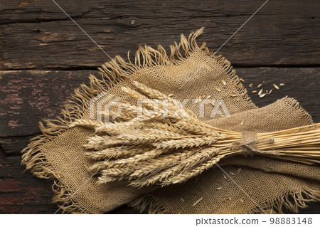 bread ears on a wooden table 98883148