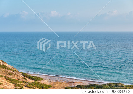 Shot of a picturesque beach of the azure mediterranean sea surrounded by a beautiful nature of Cyprus. 98884230