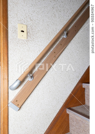 Stairs in an old detached house with handrails installed due to aging residents Stairs in an old detached house with handrails installed due to aging residents 98884967
