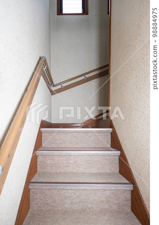 Stairs in an old detached house with handrails installed due to aging residents Stairs in an old detached house with handrails installed due to aging residents 98884975