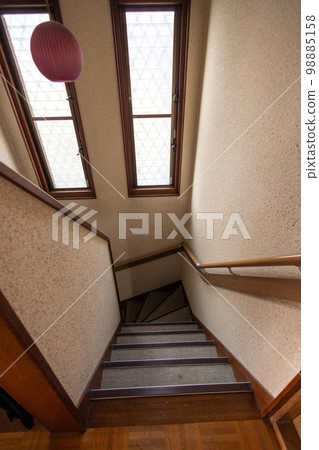 Stairs in an old detached house with handrails installed due to aging residents 98885158