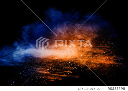 Orange blue powder explosion on black background.Orange blue color dust splashing. Orange blue powder explosion on black background.Orange blue color dust splashing. 98885396