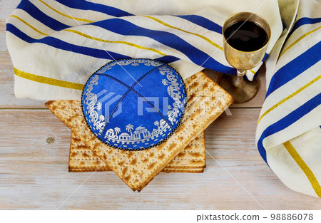 In Jewish holiday of Passover cup of kosher kiddush wine an unleavened bread matzah is included In Jewish holiday of Passover cup of kosher kiddush wine an unleavened bread matzah is included 98886078