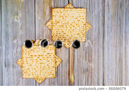 Passover Jewish holiday celebration with matzoh and kosher kiddush four cups red wine were served Passover Jewish holiday celebration with matzoh and kosher kiddush four cups red wine were served 98886079