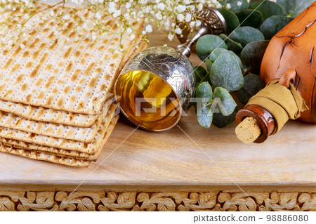 Passover festival is Jewish holiday in which unleavened bread matzah cup of kosher kiddush wine Passover festival is Jewish holiday in which unleavened bread matzah cup of kosher kiddush wine 98886080