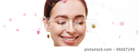 Banner portrait of young woman and confetti rain Banner portrait of young woman and confetti rain 98887249