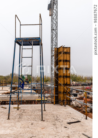 Construction site with steel formworks and reinforcing bars for pillars ready for concrete Construction site with steel formworks and reinforcing bars for pillars ready for concrete 98887672
