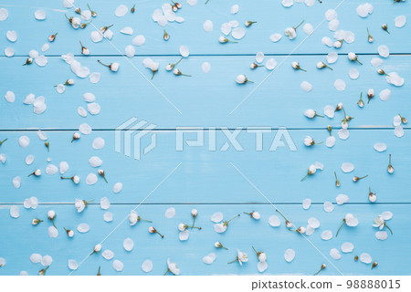 Floral frame for text on a blue wooden background 98888015