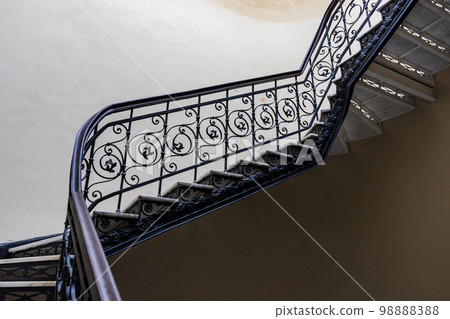 Interior of entrance hall with carved staircase 98888388