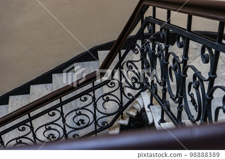 Interior of entrance hall with carved staircase 98888389