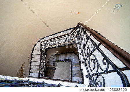 Interior of entrance hall with carved staircase 98888390