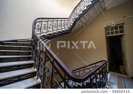 Interior of entrance hall with carved staircase Interior of entrance hall with carved staircase 98888416