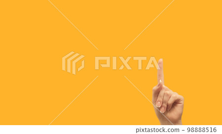 Attention gesture. Idea promotion. Information here. Female hand recommending something invisible finger pointing up at yellow empty space background. 98888516