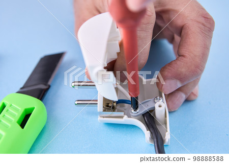 Electrical cord is connected to folding electric plug and secured with fixing screw. 98888588