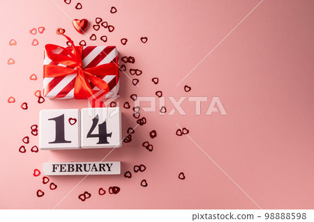 14 February Valentine's Day pink background, gift boxes, red hearts. Copy space. 98888598