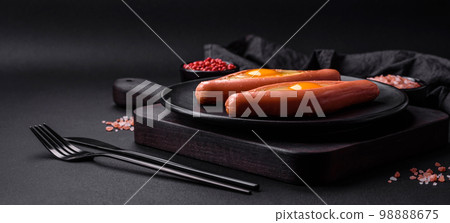 Composite concept of fried eggs inside a cut sausage with spices 98888675
