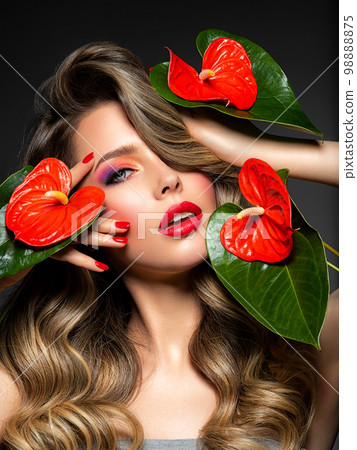 Beautiful white girl with red flowers. Stunning girl with Anthurium red. Closeup face of young beautiful blonde woman with a healthy clean skin. Pretty woman with bright makeup and long wavy hair. Beautiful white girl with red flowers. Stunning girl with Anthurium red. Closeup face of young beautiful blonde woman with a healthy clean skin. Pretty woman with bright makeup and long wavy hair. 98888875