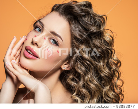 Curvy girl with trendy make-up and gorgeous curly hair posing Stock Photo