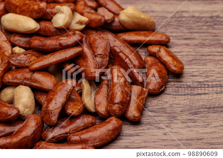 Persimmon seeds and peanuts on the table Persimmon seeds and peanuts on the table 98890609