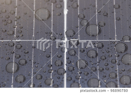 Green energy. Solar panels with raindrops close up. The use of waterproof solar panels in difficult environments, the production of green energy. Green energy. Solar panels with raindrops close up. The use of waterproof solar panels in difficult environments, the production of green energy. 98890780