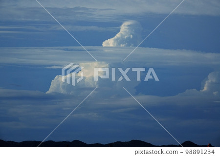 Afternoon view of cumulonimbus and various clouds appearing over distant mountains Summer 220727pm 98891234