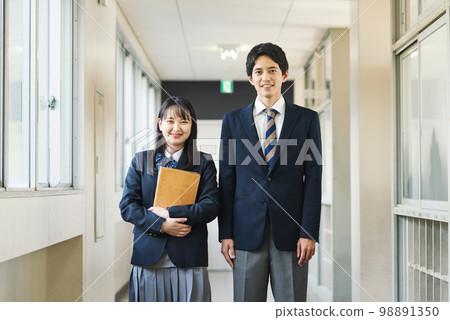 Portrait of high school students standing in school corridor Portrait of high school students standing in school corridor 98891350