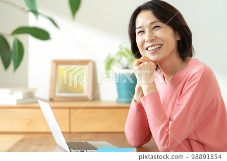 Middle-aged women thinking about asset building 98891854