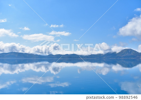 Akita Lake Tazawa with blue sky and water mirror Akita Lake Tazawa with blue sky and water mirror 98892546